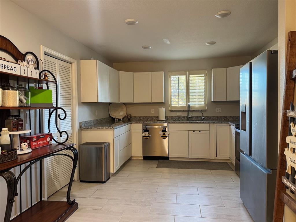 38706 River Road Dade City, FL 33525 - Photo 11 of 30 a kitchen with a sink window and cabinets