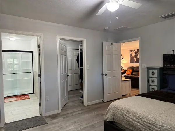a bedroom with a bed and a large mirror