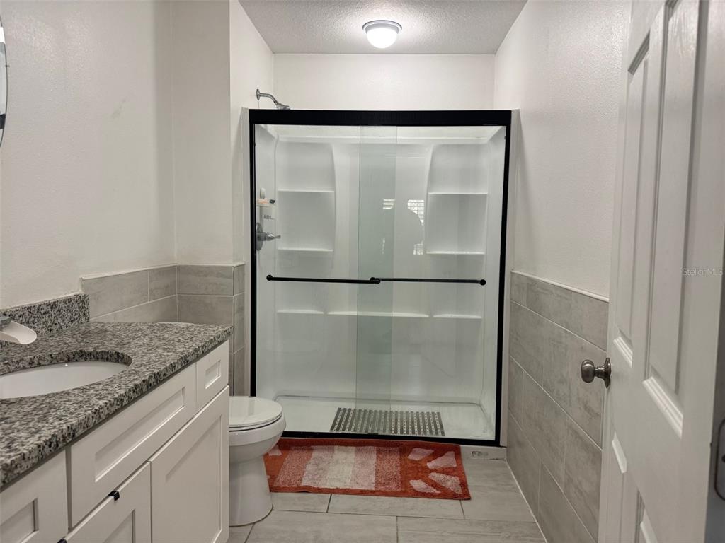 38706 River Road Dade City, FL 33525 - Photo 15 of 30 a bathroom with a granite countertop shower sink and mirror