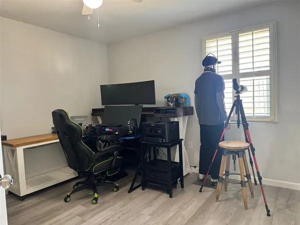 a view of a workspace with furniture and a window