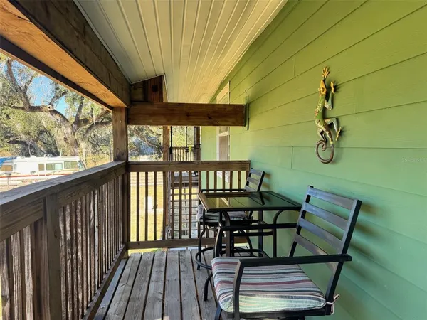 a view of a balcony with furniture