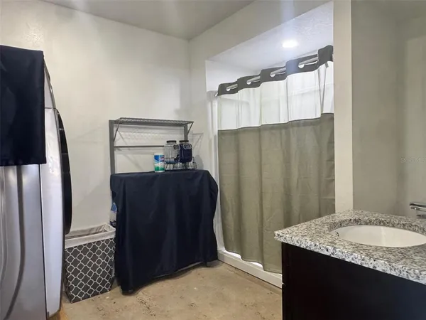 a bathroom with a granite countertop sink and a mirror