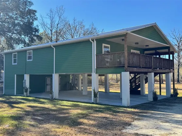 a view of a house with wooden deck