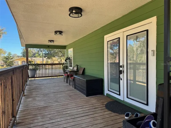 a view of a balcony with wooden floor