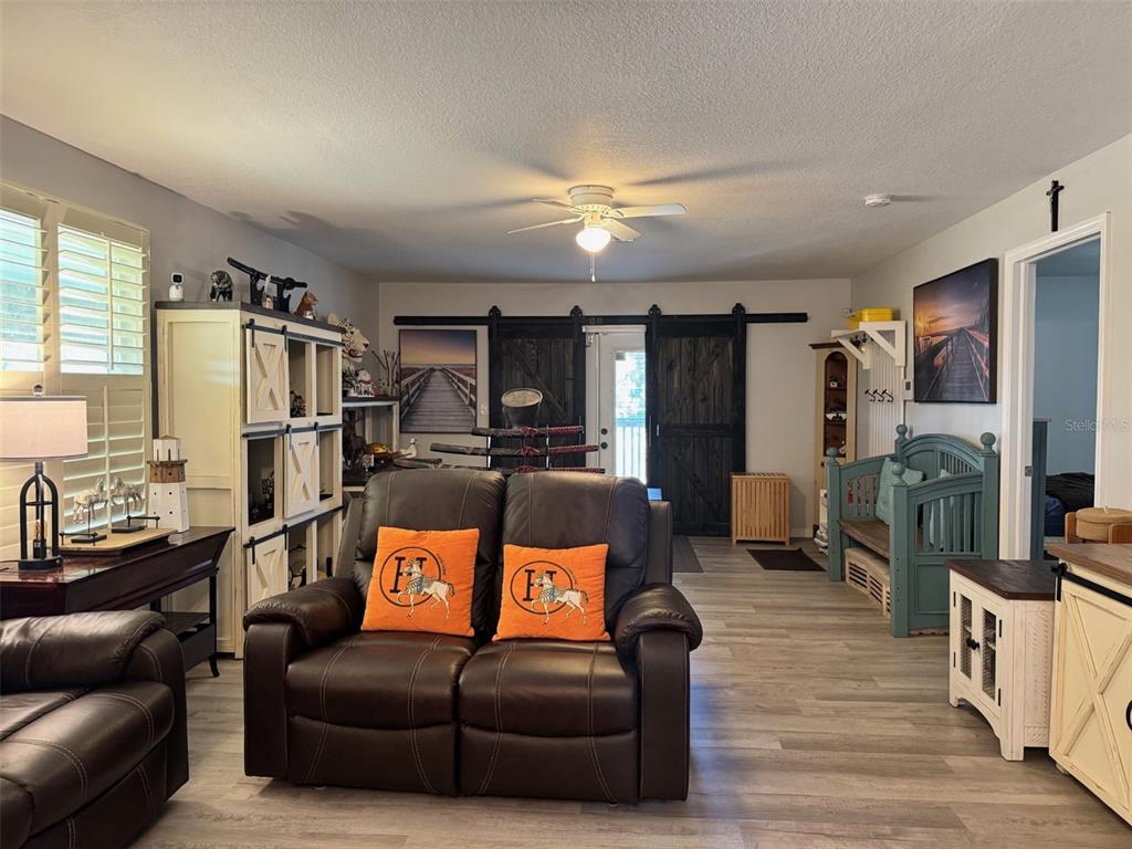 38706 River Road Dade City, FL 33525 - Photo 6 of 30 a living room with furniture and a flat screen tv