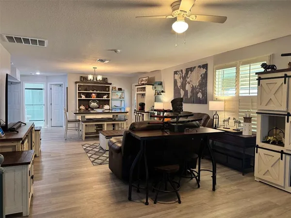 a living room with lots of furniture and kitchen view
