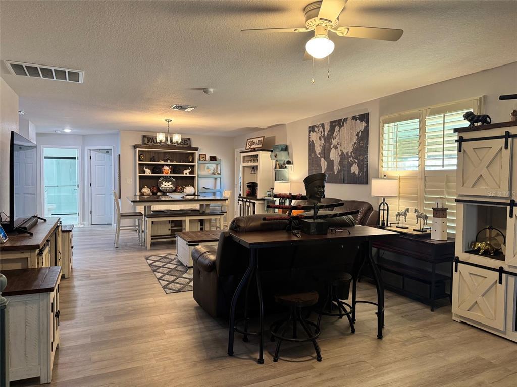 38706 River Road Dade City, FL 33525 - Photo 8 of 30 a living room with lots of furniture and kitchen view