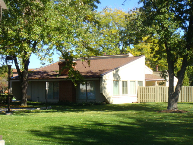 6443 Clarendon Hills Road, Unit 202 Willowbrook, IL 60527 - Photo 18 of 18 a front view of a house with a garden