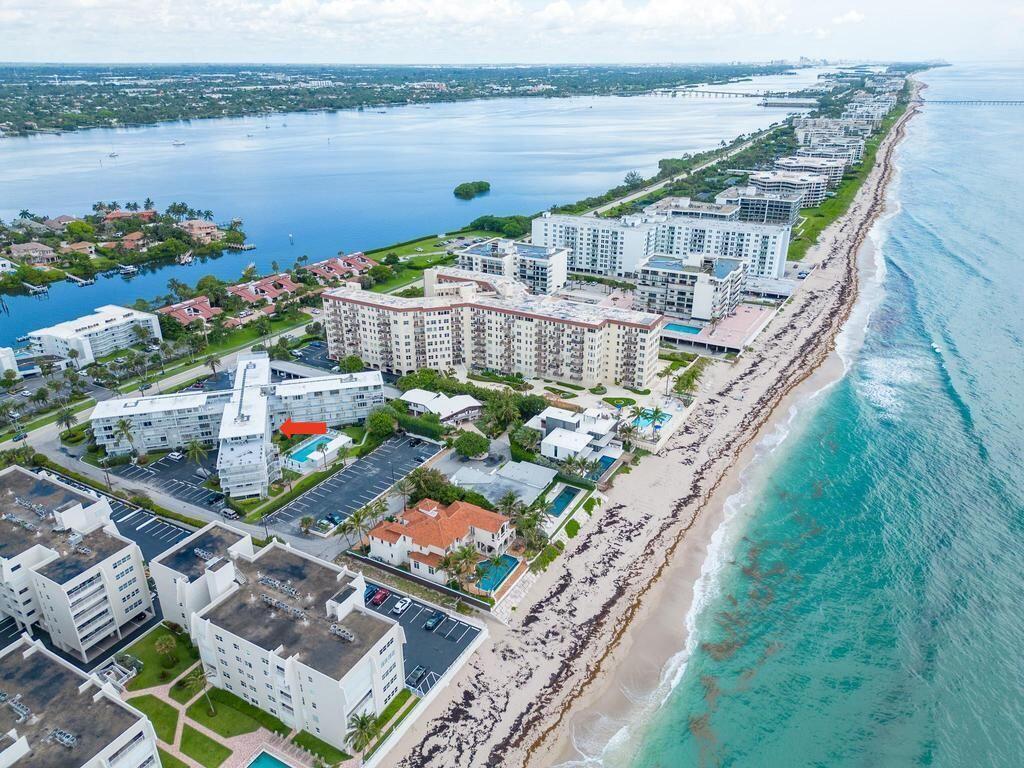 3500 South Ocean Boulevard, Unit 107 South Palm Beach, FL 33480 - Photo 1 of 24 a view of a balcony with wooden floor and outdoor seating