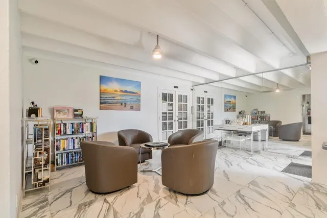 a living room with furniture and a book shelf