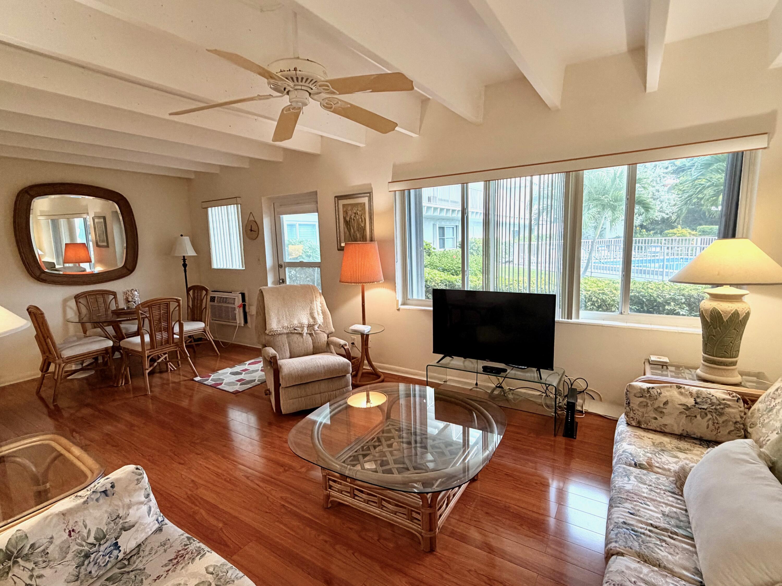3500 South Ocean Boulevard, Unit 107 South Palm Beach, FL 33480 - Photo 16 of 24 a living room with furniture a fireplace and a flat screen tv