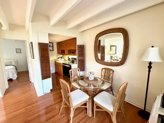 a dining room with furniture and a mirror
