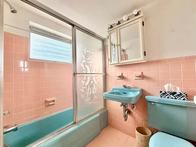 a bathroom with a sink mirror toilet and bathtub