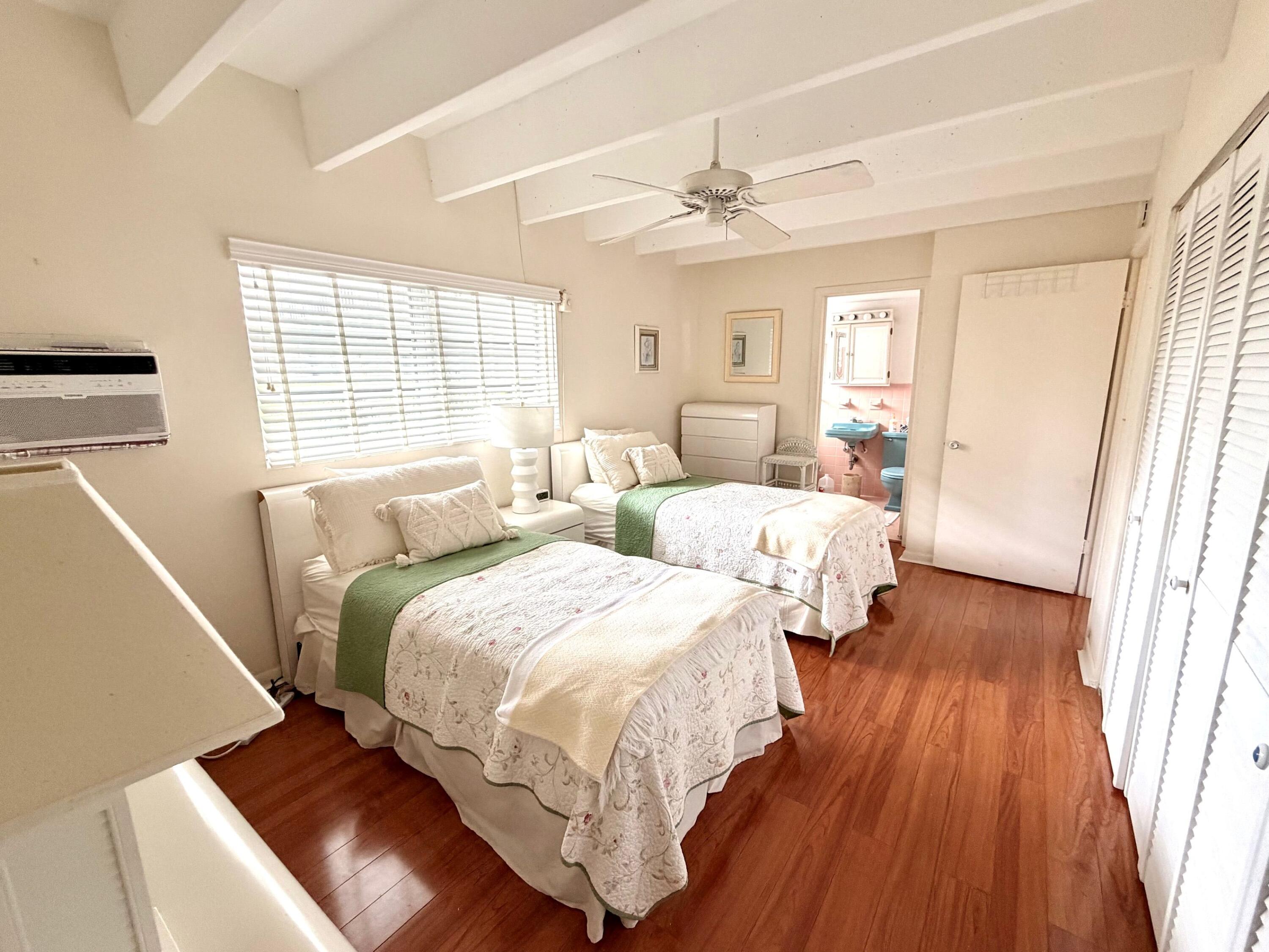 3500 South Ocean Boulevard, Unit 107 South Palm Beach, FL 33480 - Photo 22 of 24 a bedroom with two beds and wooden floors