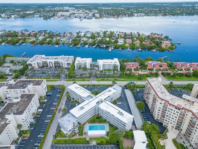 an aerial view of a house with a garden and lake view