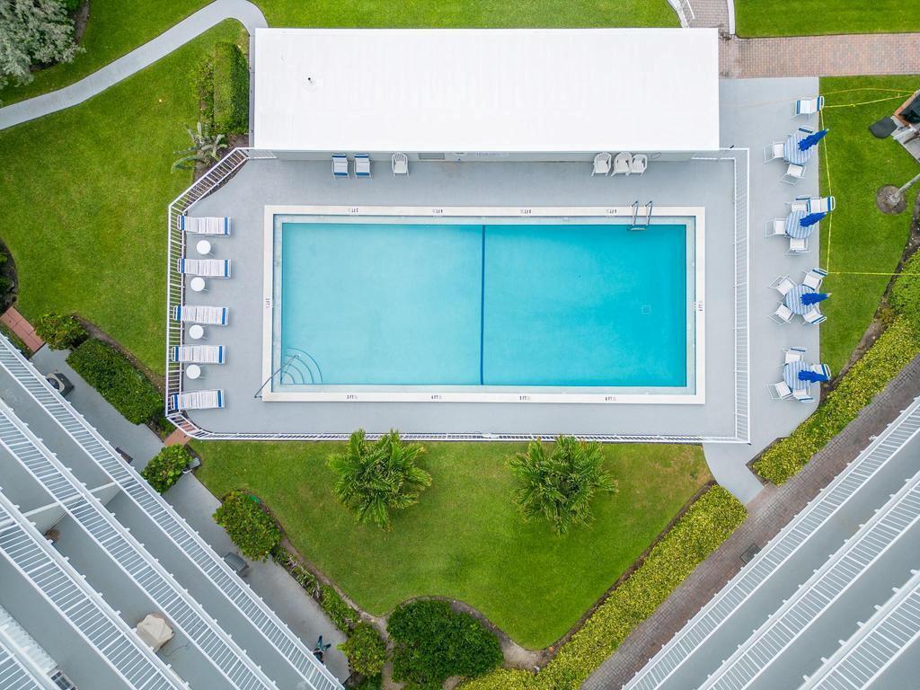 3500 South Ocean Boulevard, Unit 107 South Palm Beach, FL 33480 - Photo 9 of 24 a front view of a house with a garden