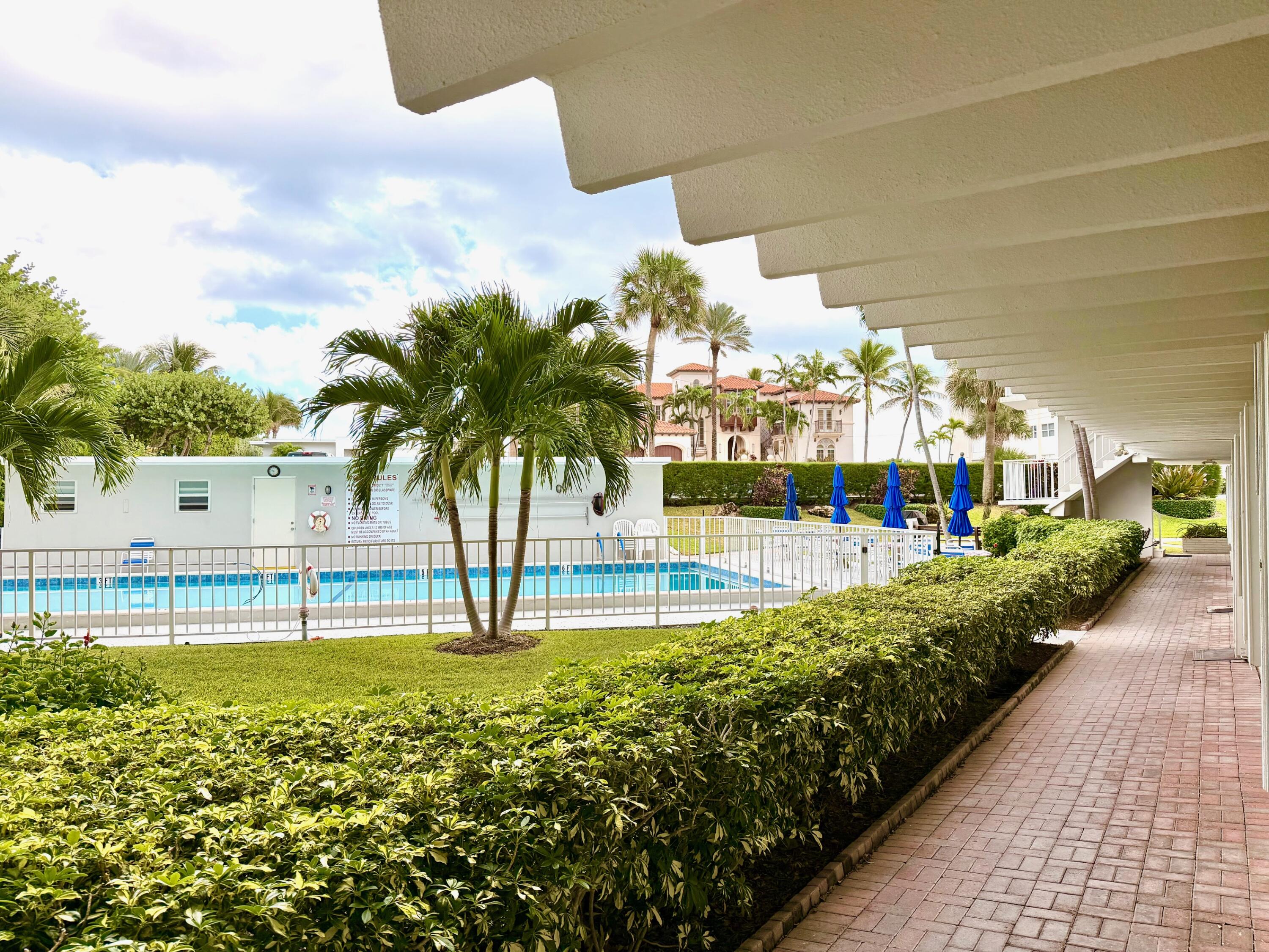 3500 South Ocean Boulevard, Unit 107 South Palm Beach, FL 33480 - Photo 10 of 24 a view of a swimming pool with an outdoor seating