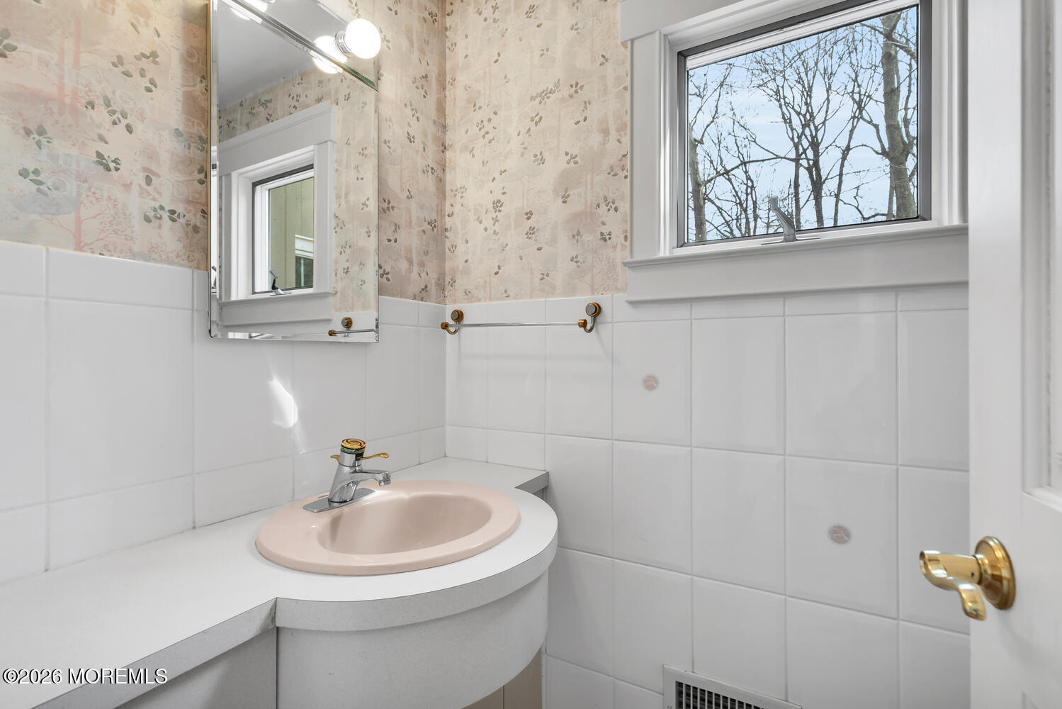 44 Tall Tree Road Middletown, NJ 07748 - Photo 21 of 62 a bathroom with a sink a window and a mirror