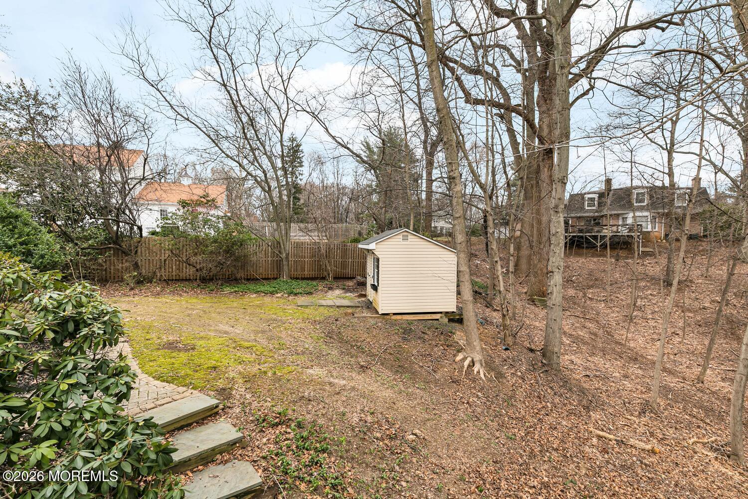 44 Tall Tree Road Middletown, NJ 07748 - Photo 10 of 62 a backyard of a house with table and chairs
