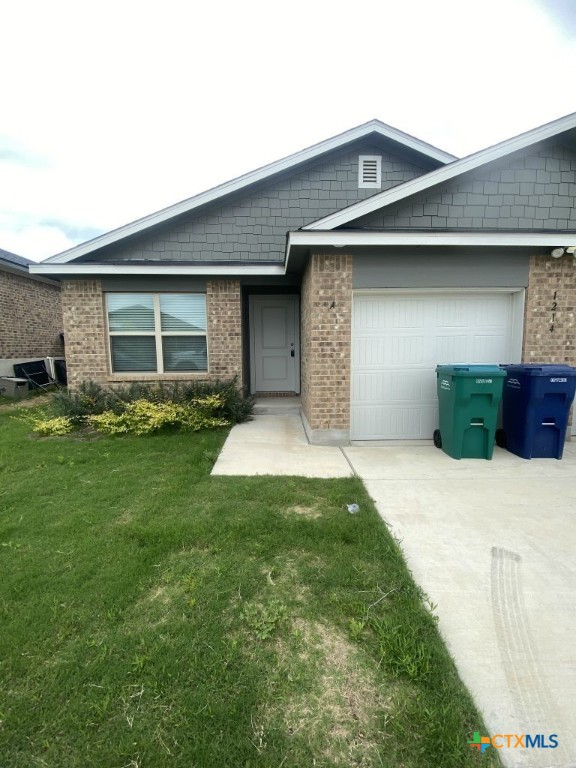 1214 Lehmann Drive, Unit A Copperas Cove, TX 76522 - Photo 1 of 24 a front view of a house with a yard and garage