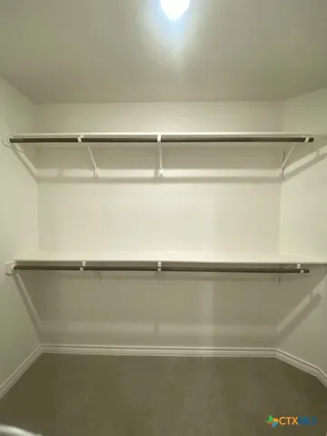 an empty room with a empty space and windows