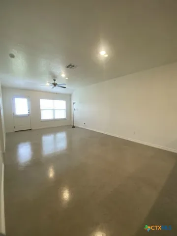 an empty room with a empty space and windows