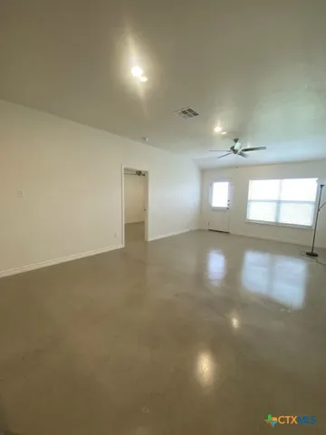 an empty room with windows and entrance