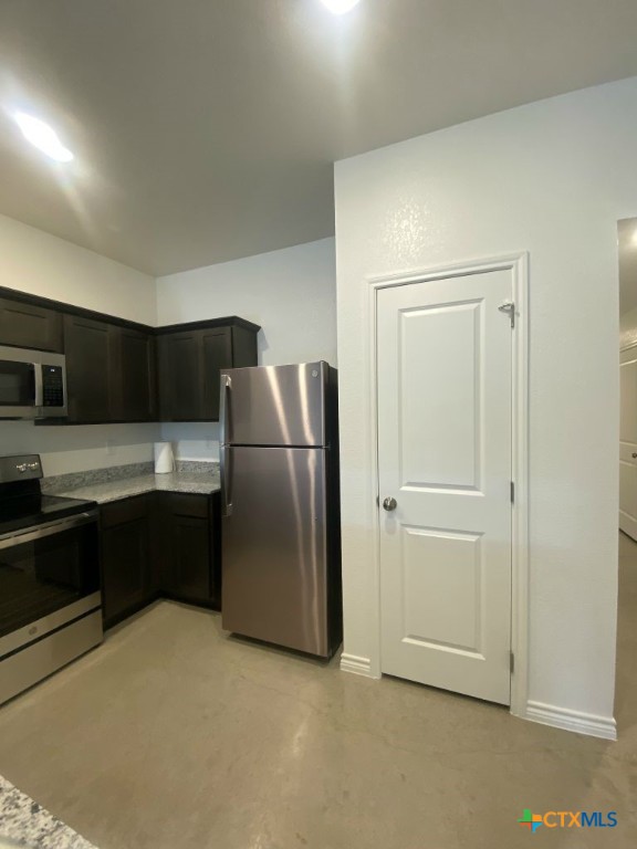 1214 Lehmann Drive, Unit A Copperas Cove, TX 76522 - Photo 7 of 24 a kitchen with a refrigerator sink and cabinets