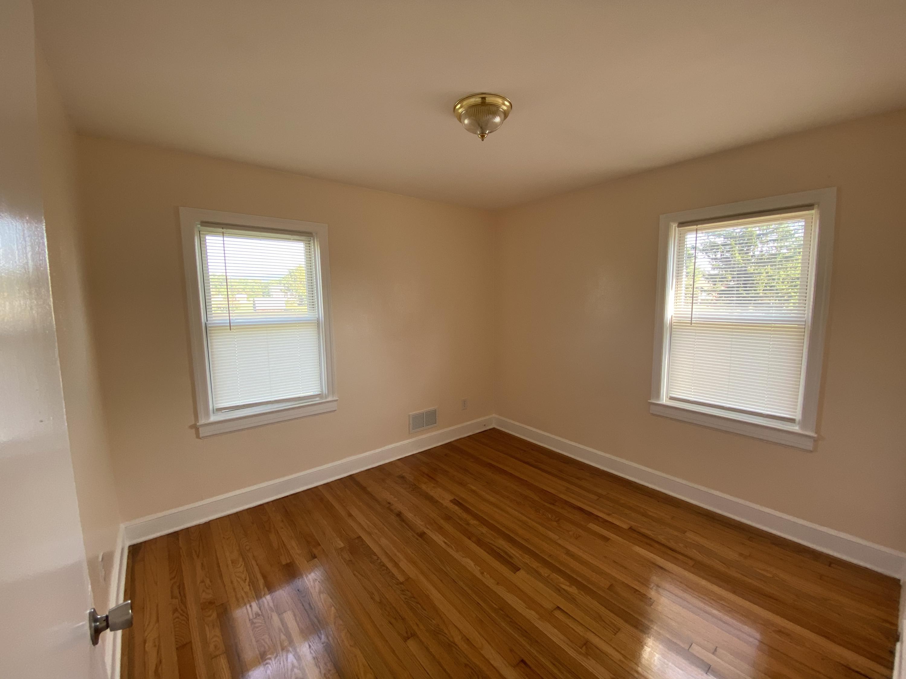 3731 Cove Road Roanoke, VA 24017 - Photo 11 of 25 a view of an empty room with wooden floor and a window