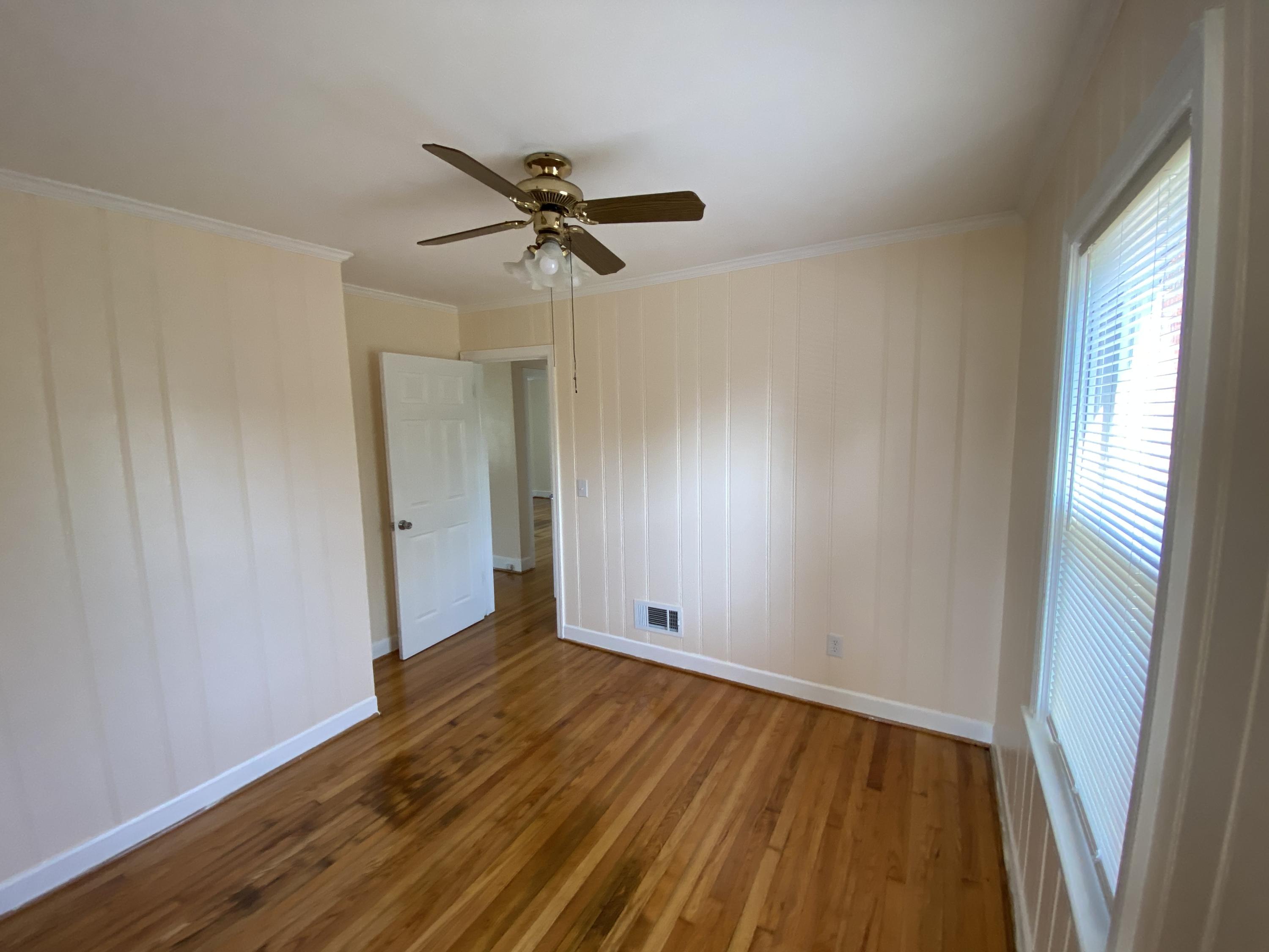 3731 Cove Road Roanoke, VA 24017 - Photo 12 of 25 a view of empty room with wooden floor and fan