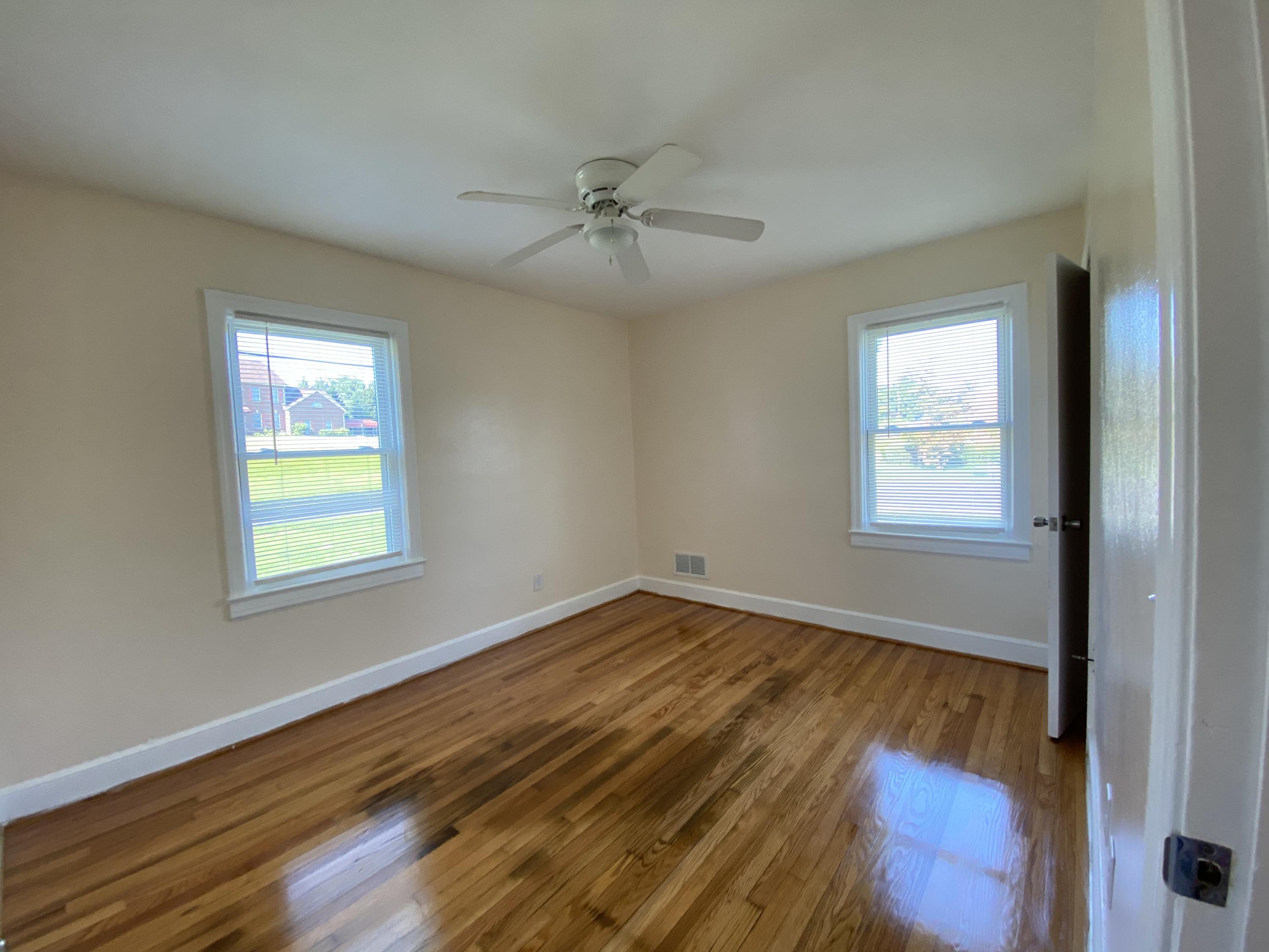 3731 Cove Road Roanoke, VA 24017 - Photo 15 of 25 a view of an empty room with wooden floor and a window