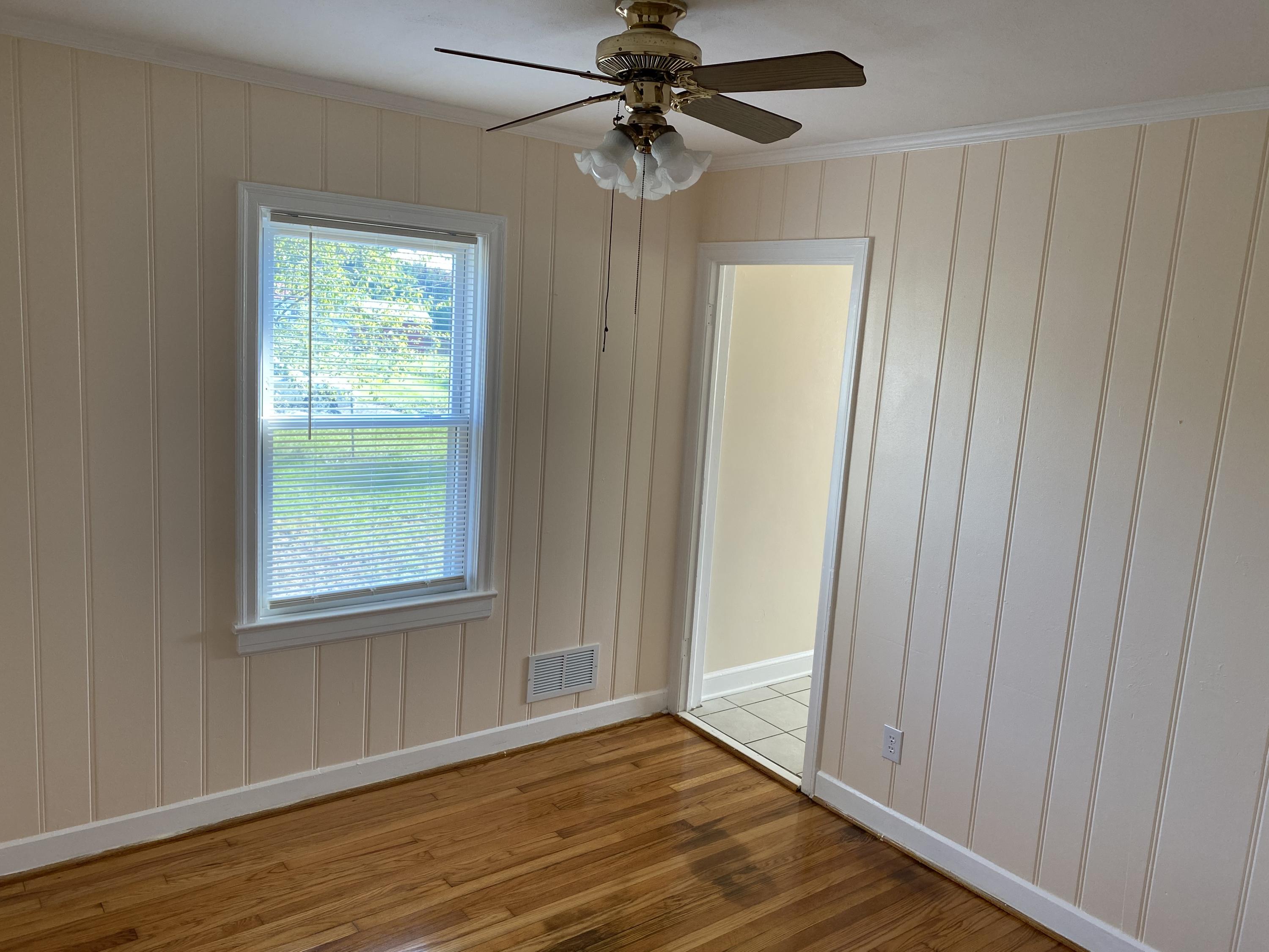 3731 Cove Road Roanoke, VA 24017 - Photo 16 of 25 a view of an empty room with wooden floor and a window