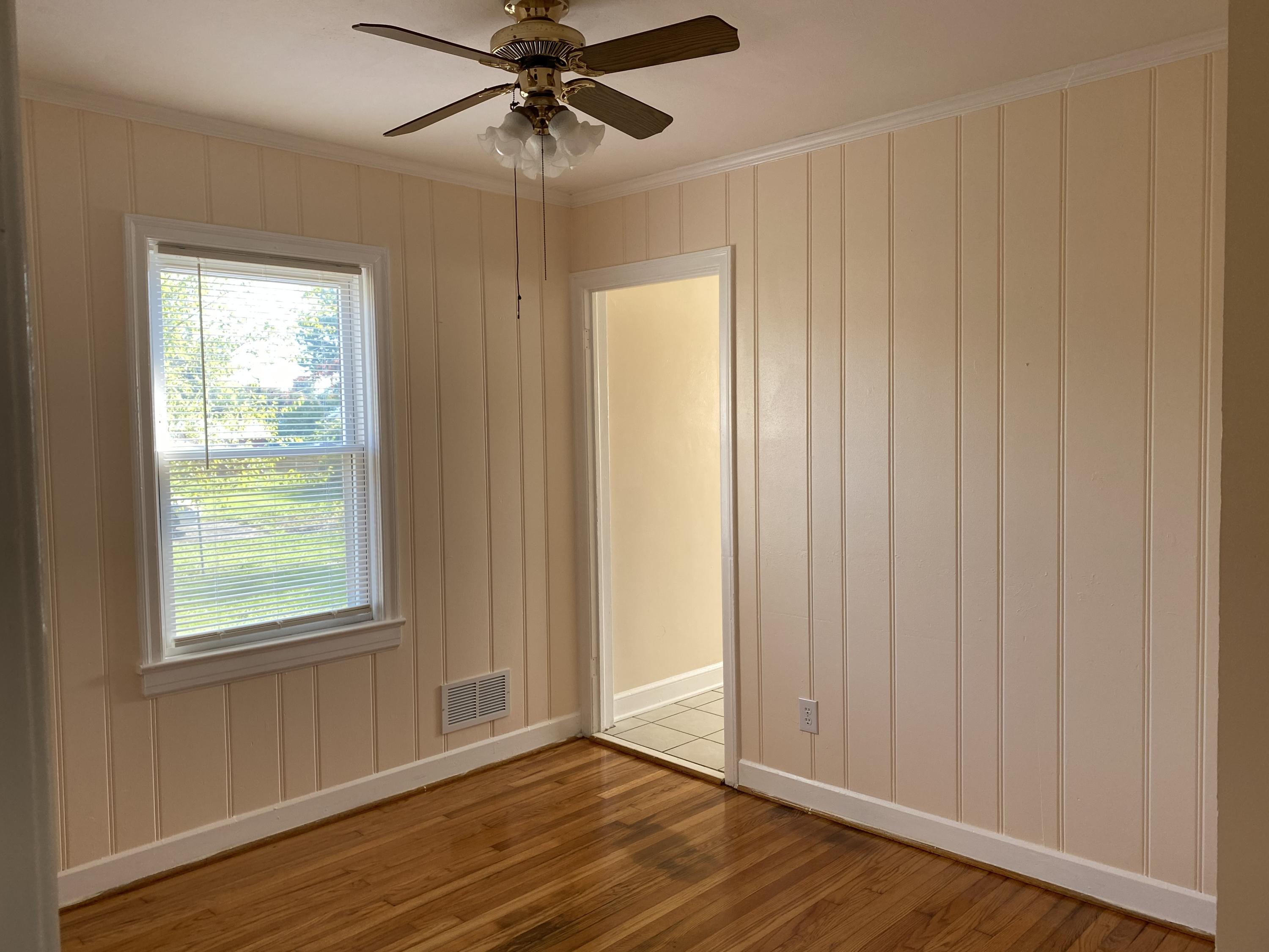 3731 Cove Road Roanoke, VA 24017 - Photo 8 of 25 a view of an empty room with wooden floor and a window