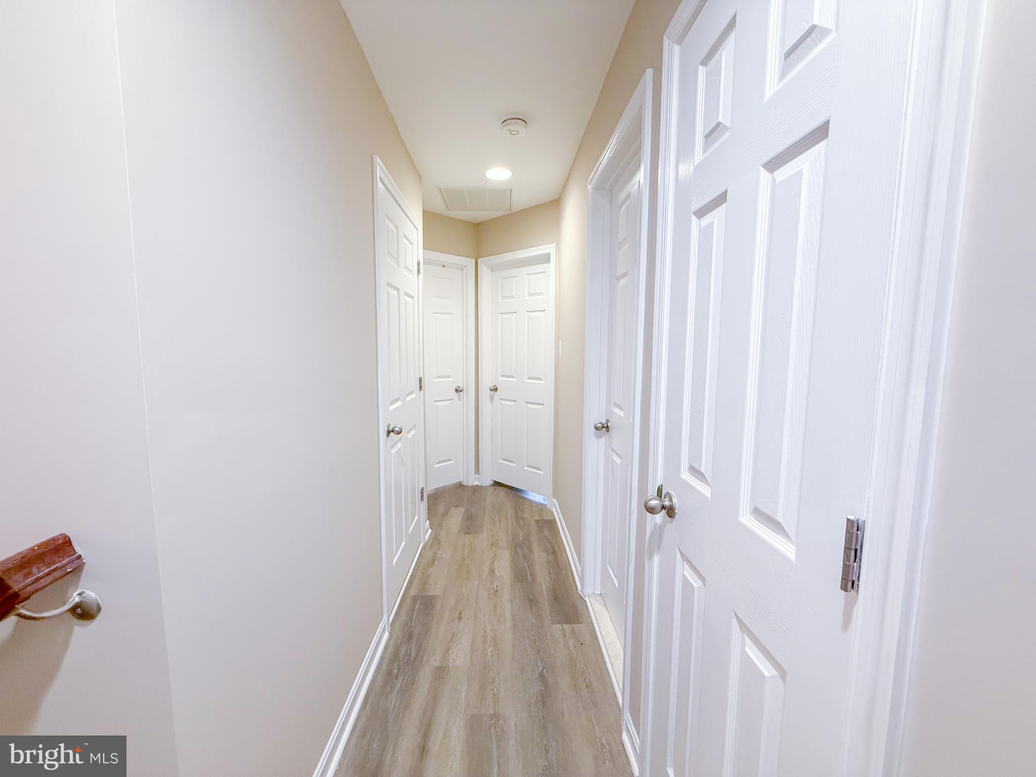 42258 Dean Chapel Square Chantilly, VA 20152 - Photo 12 of 35 a view of a hallway with wooden floor and a bathroom