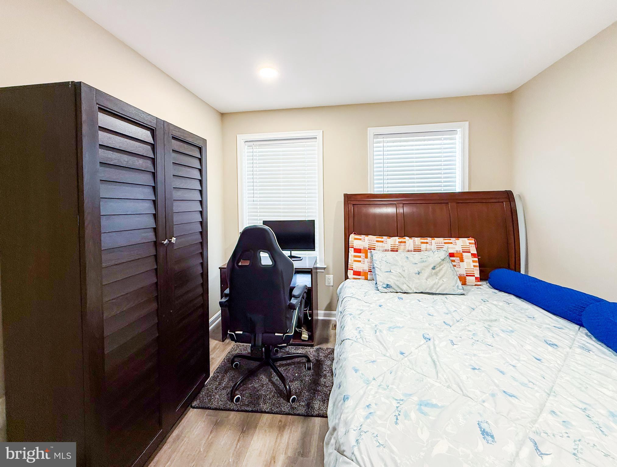 42258 Dean Chapel Square Chantilly, VA 20152 - Photo 13 of 35 a bedroom with a bed and wooden floor