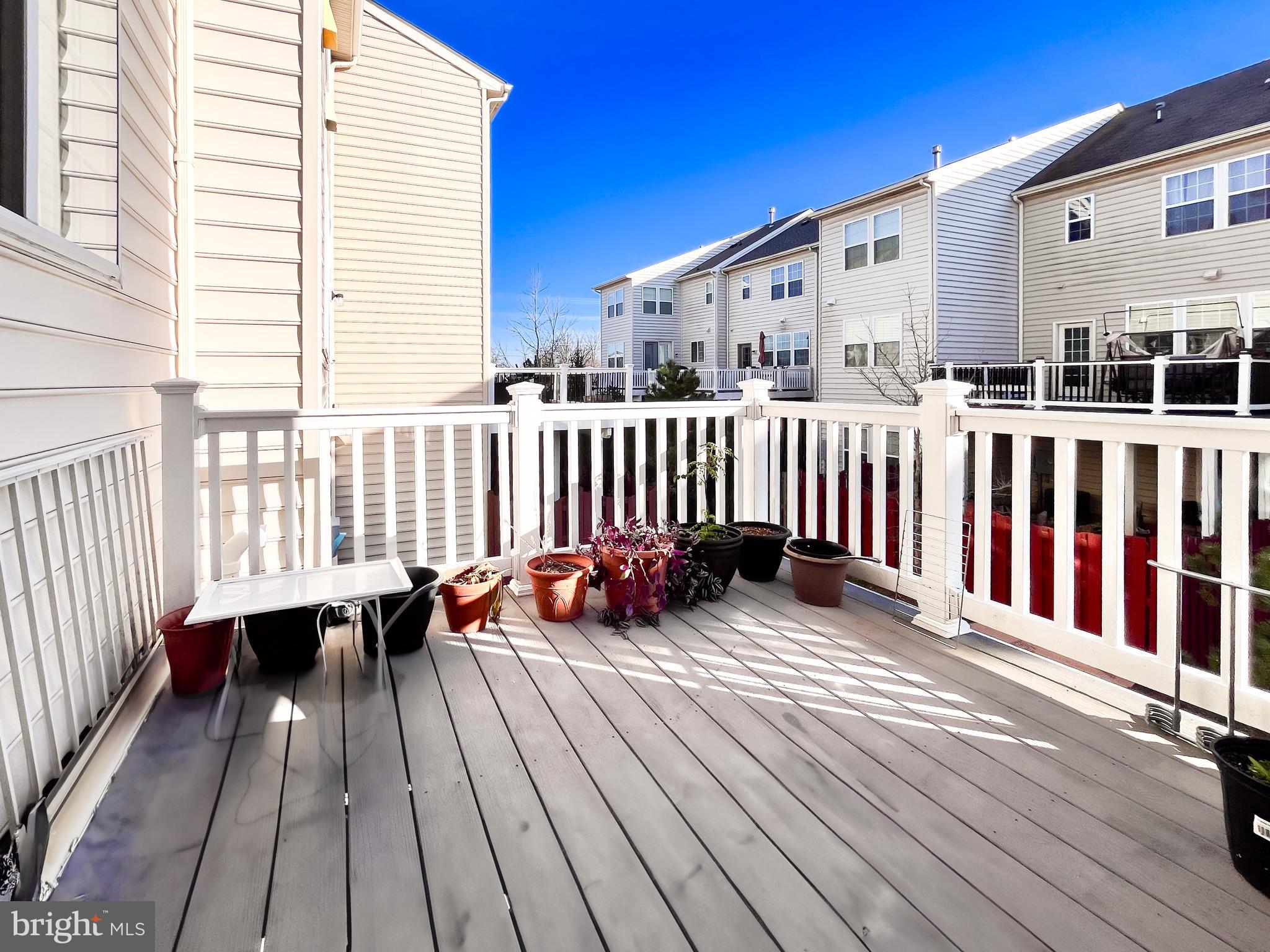42258 Dean Chapel Square Chantilly, VA 20152 - Photo 28 of 35 a view of a roof deck with wooden floor and fence