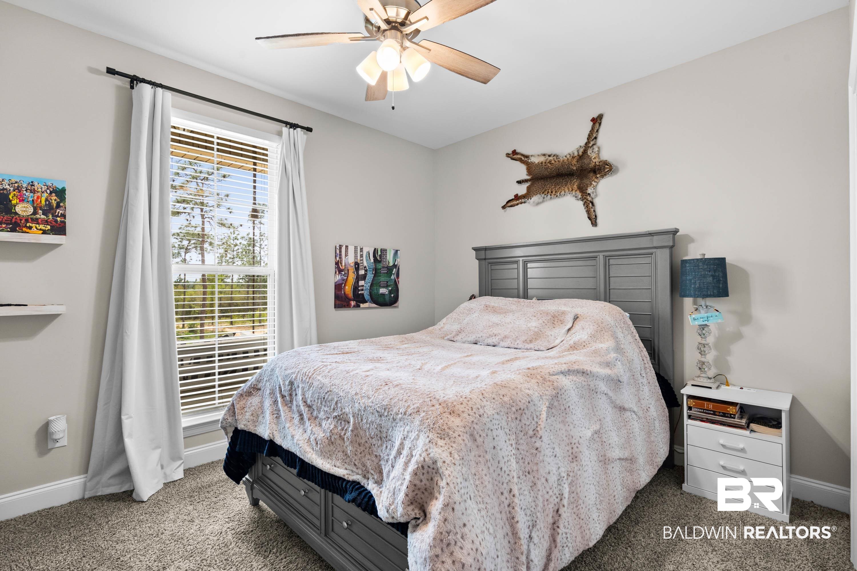 7150 Powell Road, Unit LOT 6A Eight Mile, AL 36613 - Photo 18 of 35 Bedroom featuring a ceiling fan and dark carpet