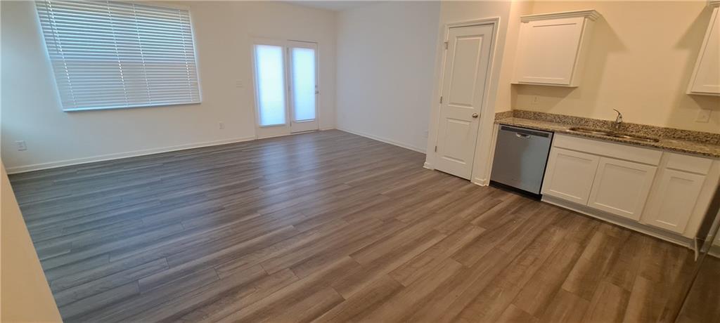 1683 Vernon Boulevard Decatur, GA 30035 - Photo 6 of 14 an empty room with wooden floor and cabinet