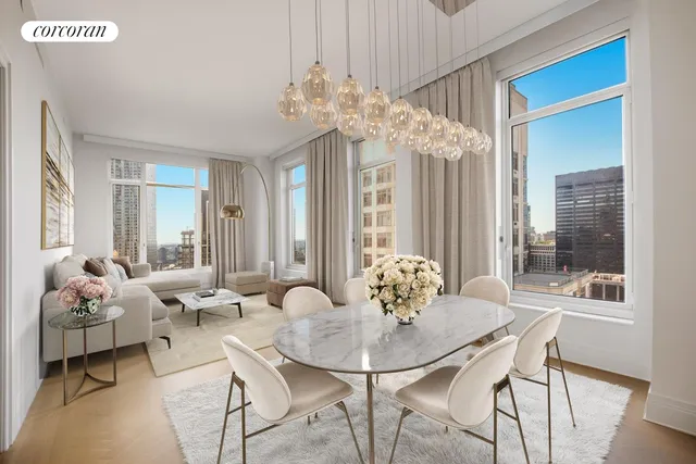 a dining room with furniture a chandelier and wooden floor