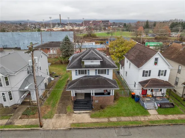 an aerial view of houses with yard