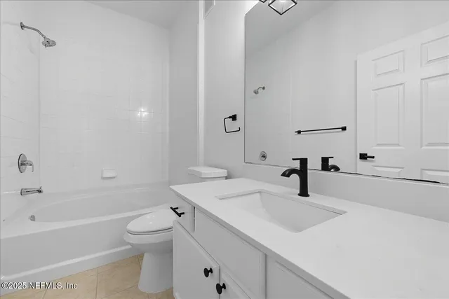 a bathroom with a sink toilet vanity and bathtub