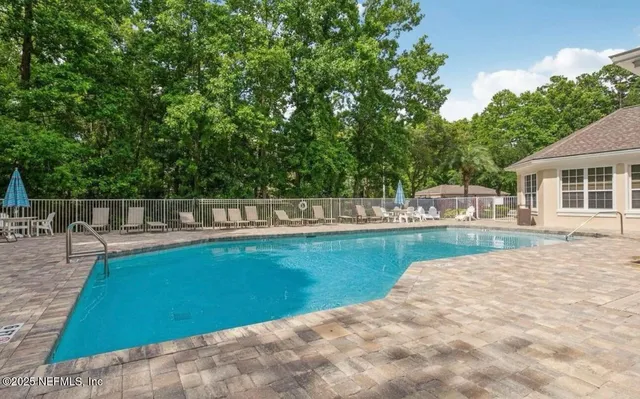 a view of a swimming pool with a patio