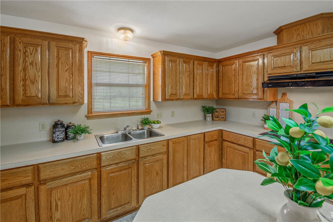 1110 County Road 439 Dime Box, TX 77853 - Photo 23 of 50 a kitchen with stainless steel appliances a sink a window cabinets potted plant and a window