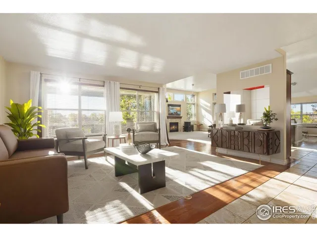 a kitchen with stainless steel appliances kitchen island granite countertop a refrigerator a stove a sink a dining table and chairs