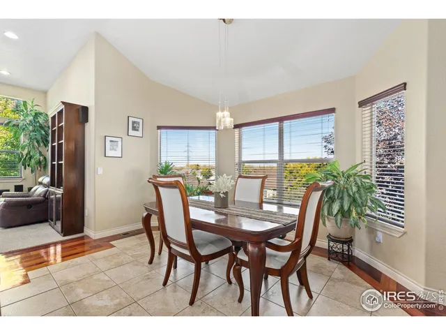 a living room with furniture a chandelier and a fireplace