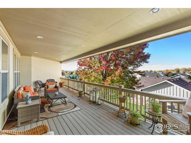 a bedroom with a large bed a couch and potted plant