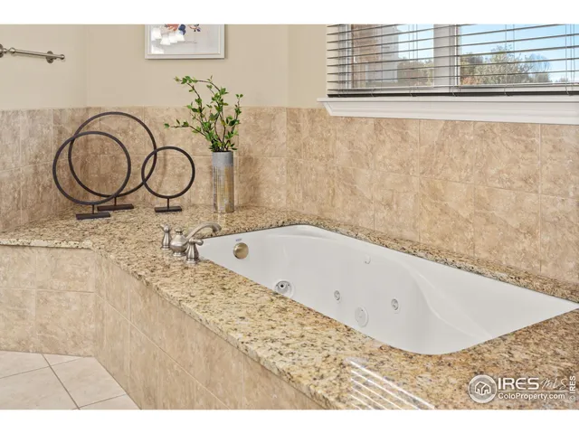 a kitchen with stainless steel appliances granite countertop a sink a stove and a refrigerator with wooden cabinets