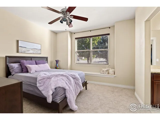 a bathroom with a granite countertop sink a toilet a mirror and shower