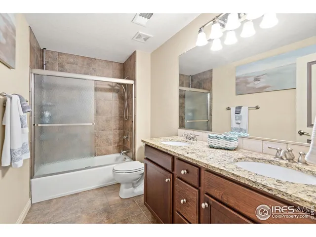 a bedroom with a bed a chandelier and a window