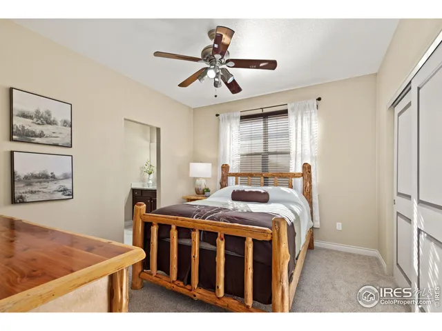 a bathroom with a granite countertop sink vanity mirror and toilet